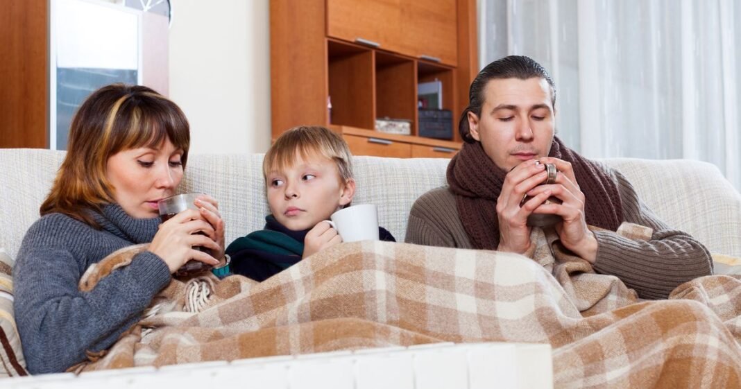 0_freezing-family-of-three-warming-near-warm-radiator