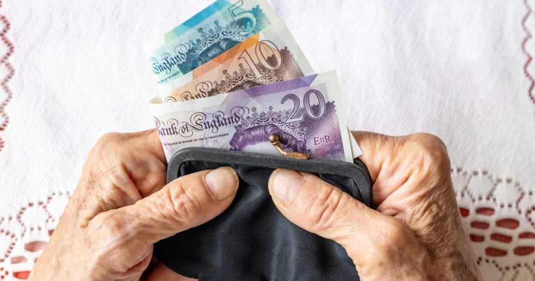 0_pensioner-holding-cash-in-a-purse