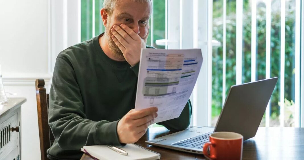 0_worried-man-checking-bills-at-home