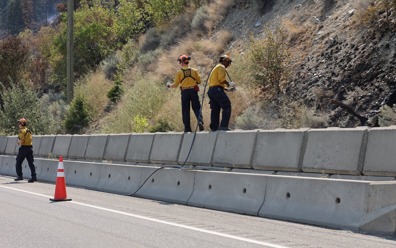 Firefighters at work near Summerland on Thursday.